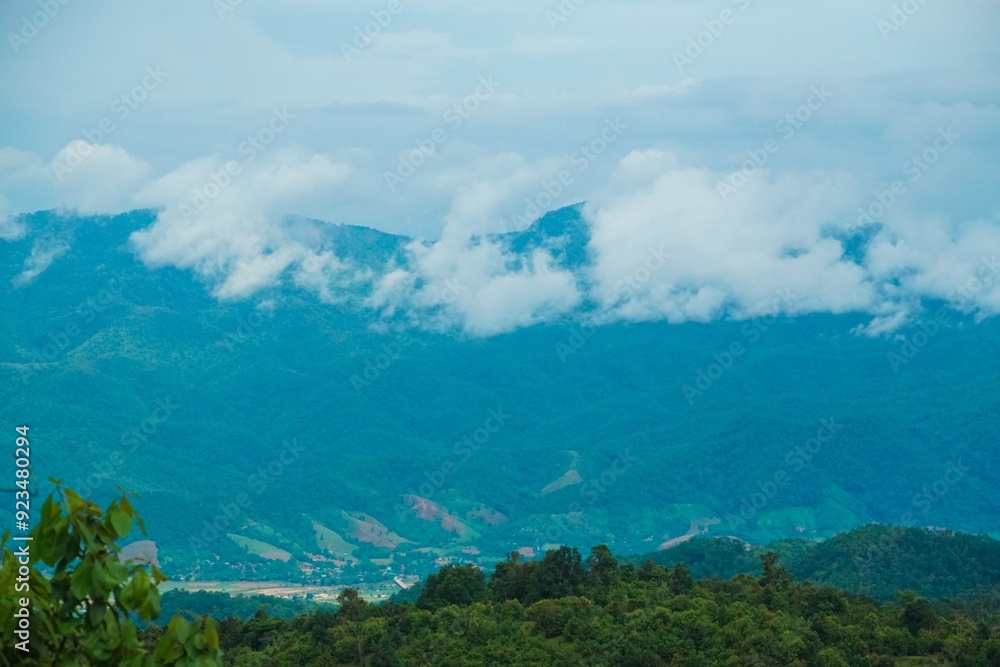 The sky is cloudy and the mountains are in the background