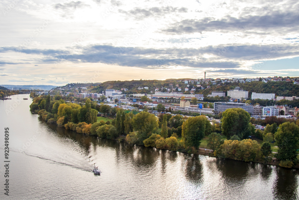 Obraz premium panoramic view of autumn Prague in October, view of the river with a boat and the city in October