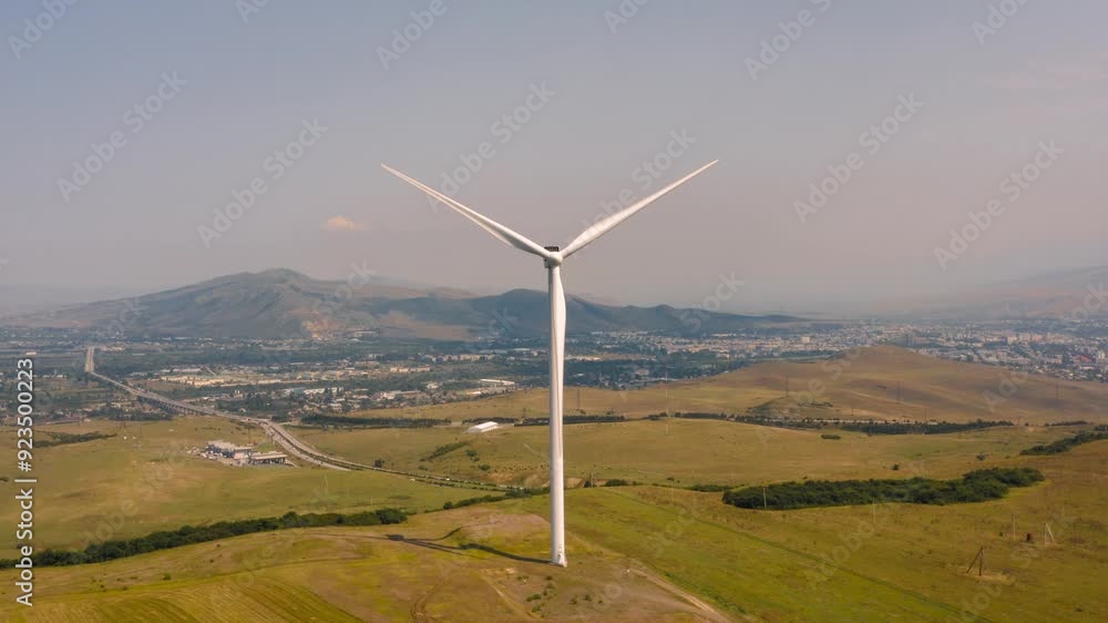 Aerial view of wind turbine rotating and generating energy Aerial view of wind turbine rotating and generating energy