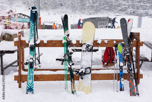 Skis, ski poles and snowboards are fully equipped on snow-covered mountain top during the ski season