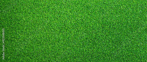 Artificial grass, covering. Artificial green grass mat, top view. Texture. Background. Artificial turf, surface made of synthetic fibers. Flat green grass texture background. Short grass
