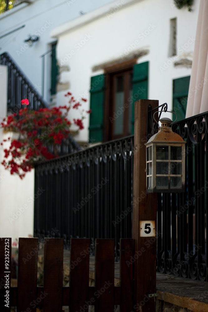 Lantern in the yard with a white house in the background, Cyprus. Lantern in the yard with a white house in the background, Cyprus.