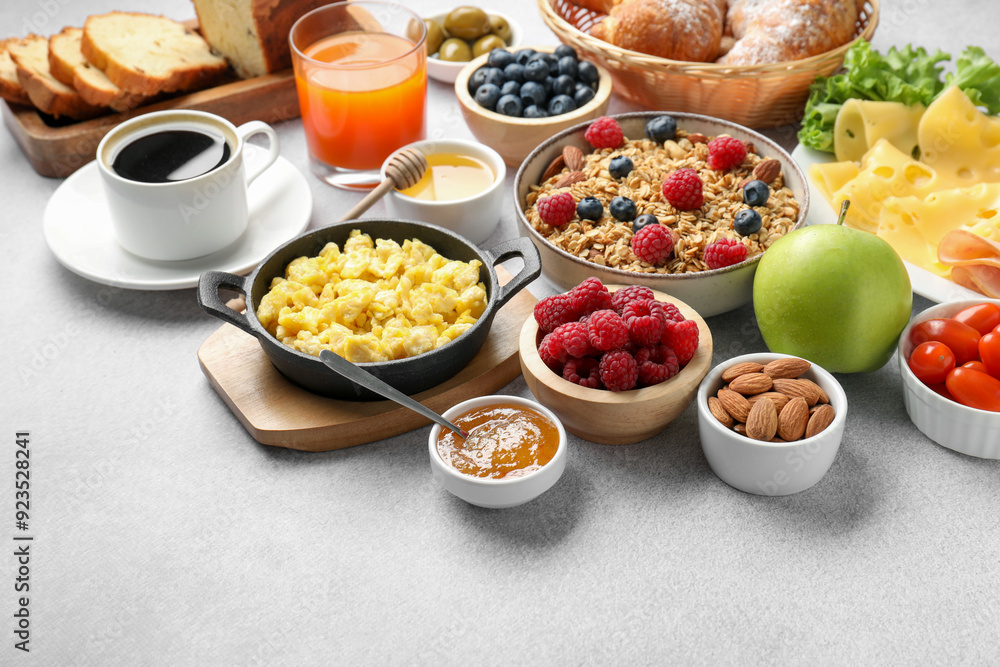 Tasty breakfast. Many different food and drinks on grey textured table Tasty breakfast. Many different food and drinks on grey textured table