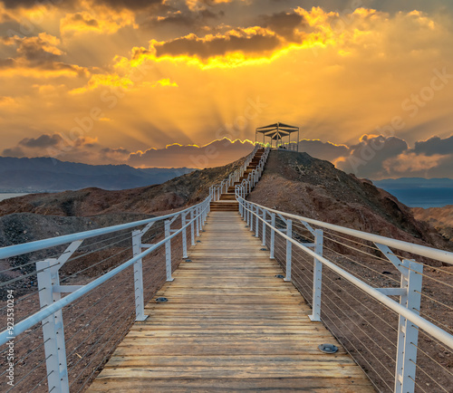 Wooden steps leading to observation point on the top of stone mount in desert...
