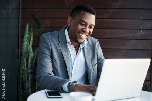 Typing, laptop and businessman at office for communication with client for feedback on investment growth. Finance, computer and African underwriter with report for online financial risk evaluation.