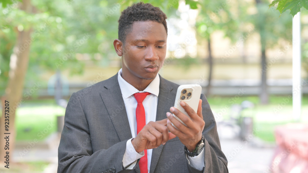 African Businessman Using Smartphone Outdoor