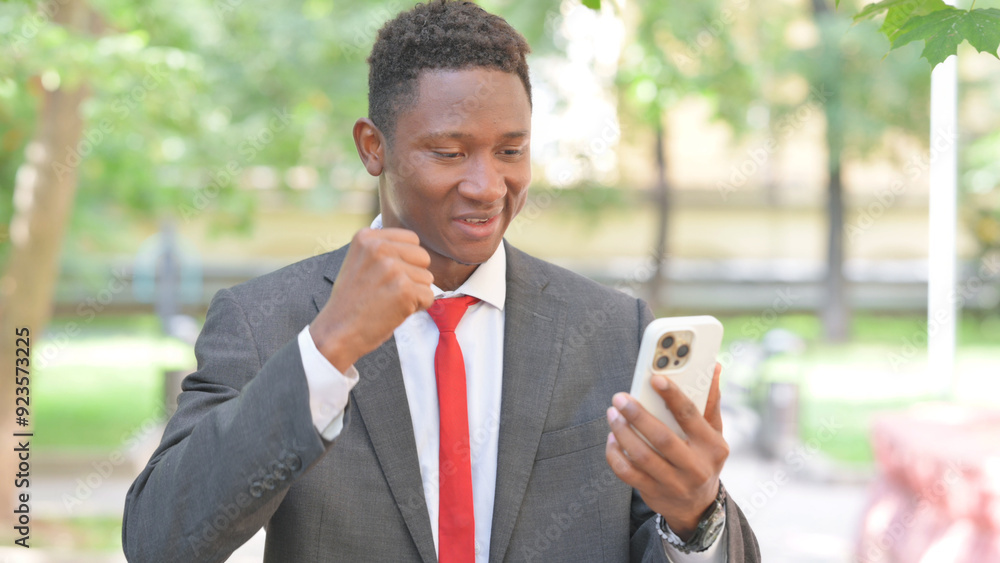 African Businessman Celebrating Trade on Phone Outdoor African Businessman Celebrating Trade on Phone Outdoor