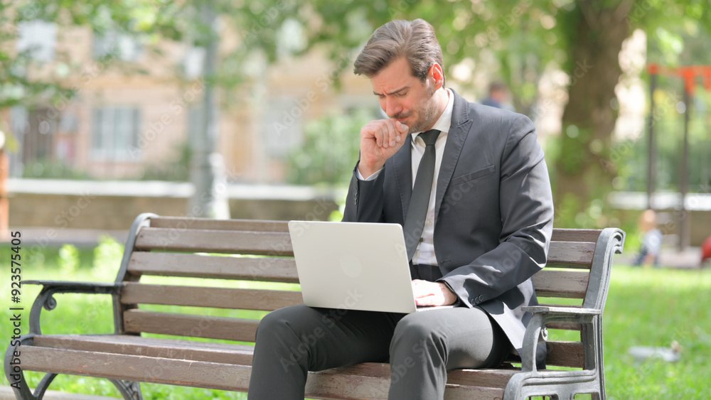 Sick Middle Aged Businessman Coughing while Using Laptop Outdoor Sick Middle Aged Businessman Coughing while Using Laptop Outdoor