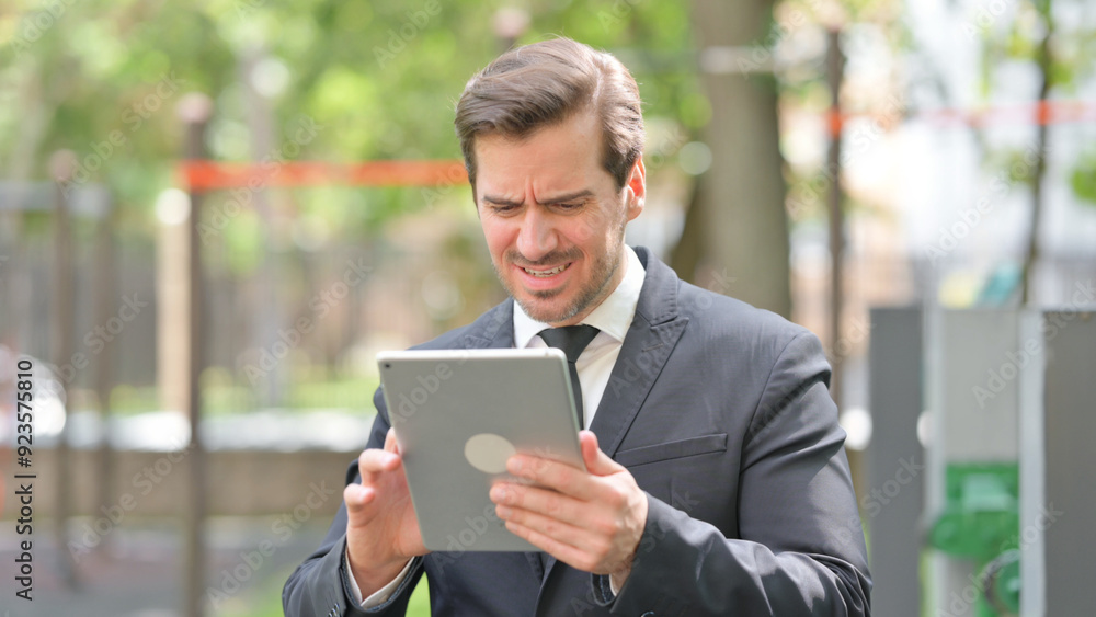 Portrait of Young Businessman with Loss on Digital Tablet Portrait of Young Businessman with Loss on Digital Tablet