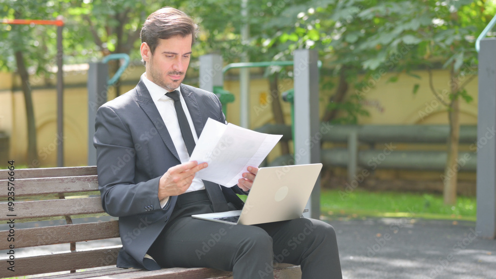 Young Businessman Doing Paperwork with Laptop Outdoor Young Businessman Doing Paperwork with Laptop Outdoor