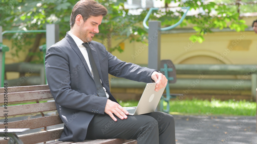 Businessman Coming, Sitting Outdoor and Working on Laptop Businessman Coming, Sitting Outdoor and Working on Laptop
