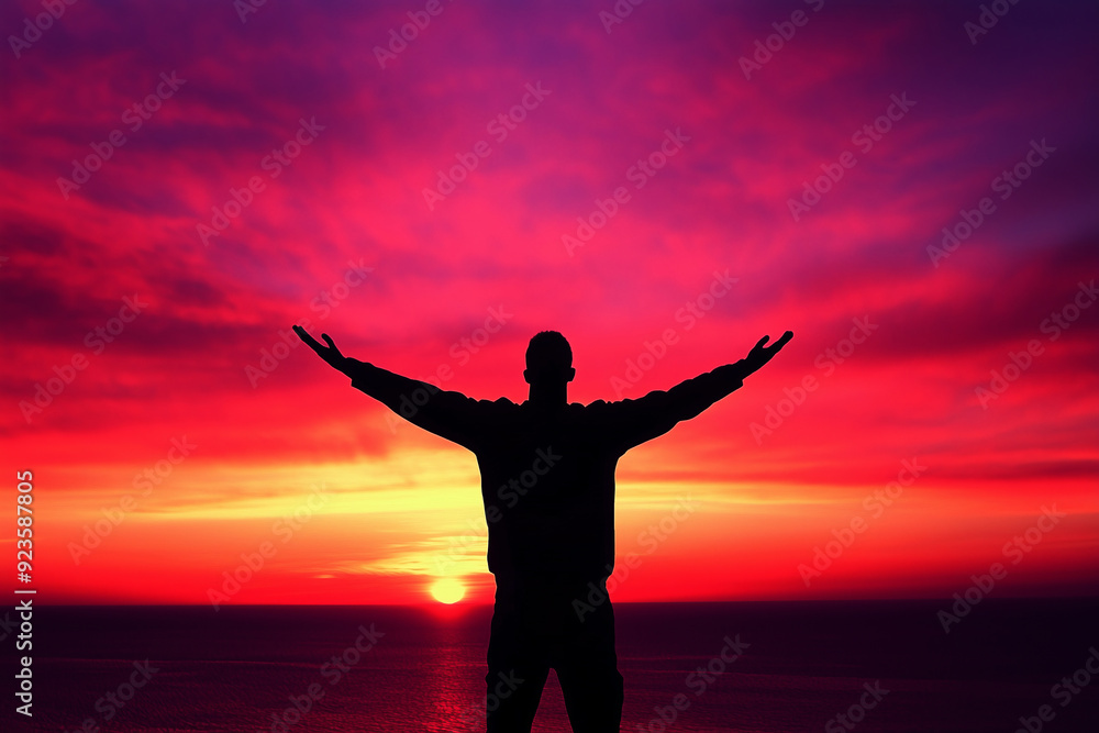Silhouetted Man with Arms Outstretched at Vibrant Sunset, Embracing the Horizon Silhouetted Man with Arms Outstretched at Vibrant Sunset, Embracing the Horizon