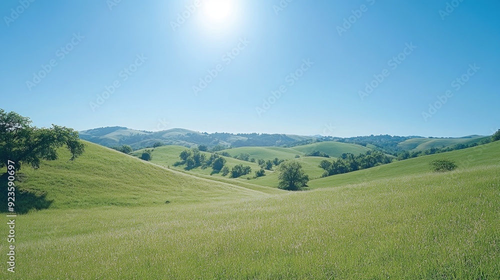 Fototapeta premium A peaceful rural landscape with rolling hills and a clear blue sky, perfect for a calming screen saver.
