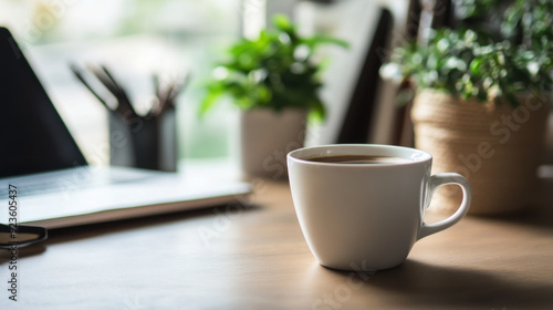 A tidy workspace with a coffee cup, showcasing a simple and clean lifestyle in the office.