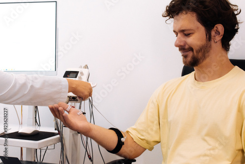 A patient undergoes nerve testing using electromyography (EMG). Perfect for illustrating advanced medical examinations and diagnosing neuromuscular disorders.