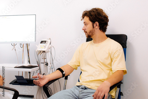 A patient undergoes nerve testing using electromyography (EMG). Perfect for illustrating advanced medical examinations and diagnosing neuromuscular disorders.
