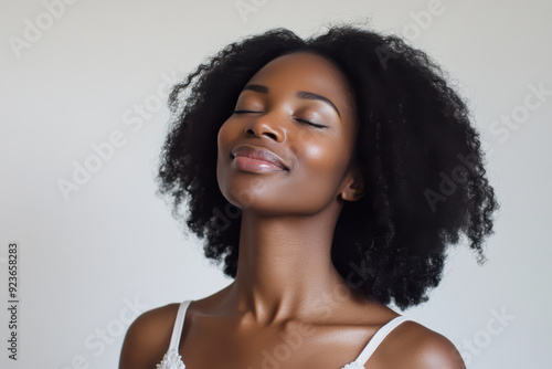 A close up of a black woman's face with her eyes closed