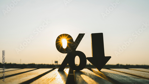 Slika na platnu Percentage model and down arrow with evening sky