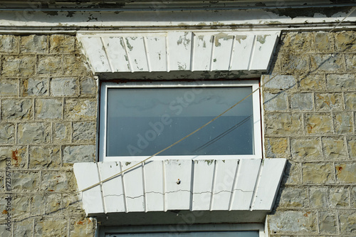 an old building in the city, a window with a brick antique frame. background for the design. photo