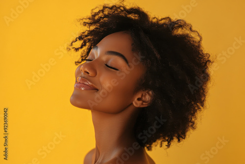 A close up of a black woman's face with her eyes closed