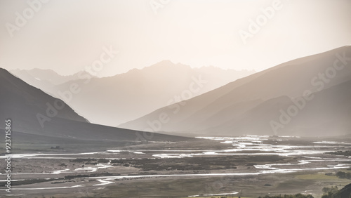 Silhouette of mountain ranges, panorama of Wakhan corridor and Panj river in valley in Pamir in Tajikistan Tien Shan mountains, morning at dawn minimalistic landscape for background photo