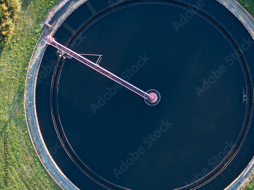 Aerial view of modern wastewater treatment plant with storage tanks in sunset. Ideal for wastewater management theme.