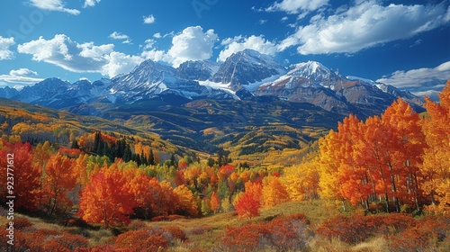 A majestic mountain range in autumn, with colorful foliage, clear blue skies, and a peaceful valley below, showcasing the beauty of nature in the fall season