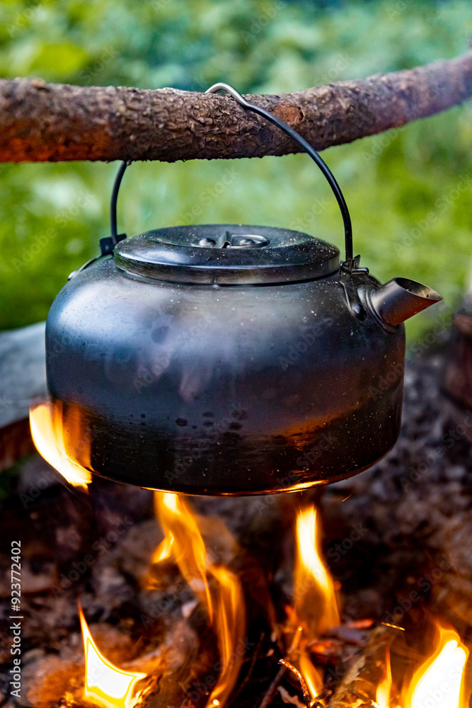 Coffee pot on a campfire during a hike in the mountains. Coffee pot on a campfire during a hike in the mountains.