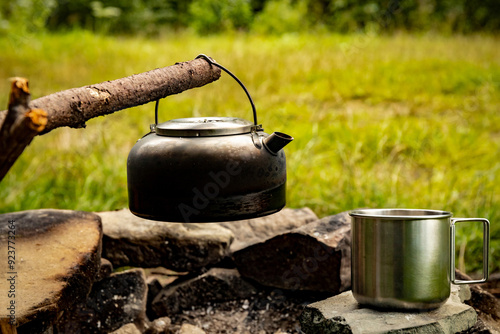 Coffee pot on a campfire during a hike in the mountains. photo