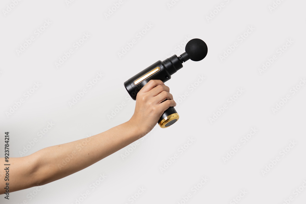 hand holding massage gun, theraphy or chiropractic concept hand holding massage gun, theraphy or chiropractic concept