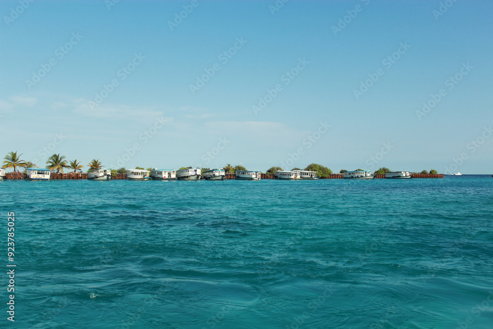 Fototapeta premium Breathtaking Serene of Maldives Coastal View of Charming Beachfront Boats 