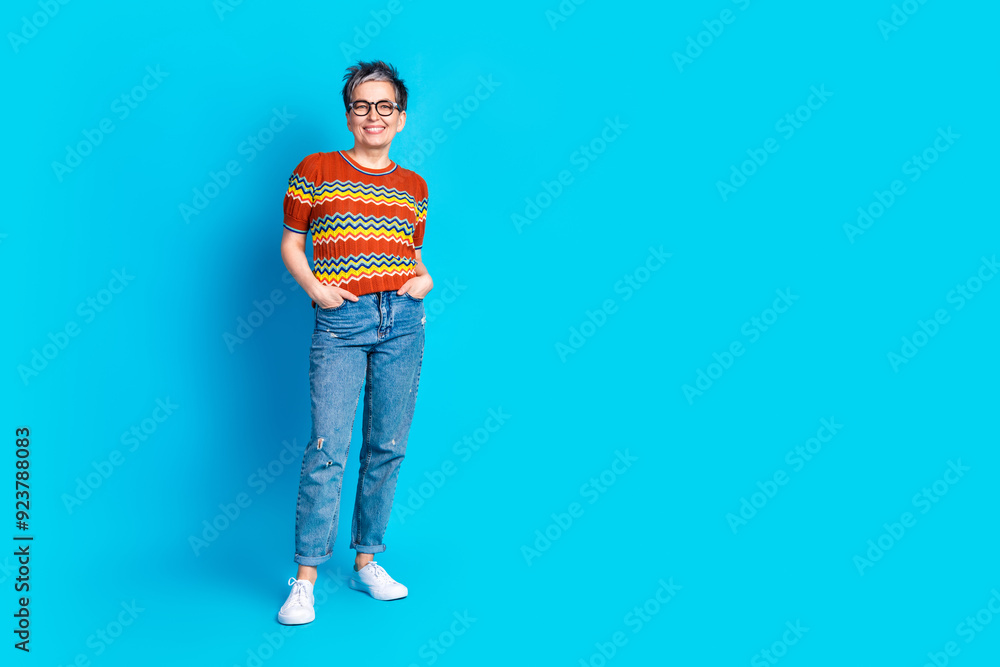 Full body portrait of nice aged lady posing empty space wear t-shirt isolated on blue color background Full body portrait of nice aged lady posing empty space wear t-shirt isolated on blue color background