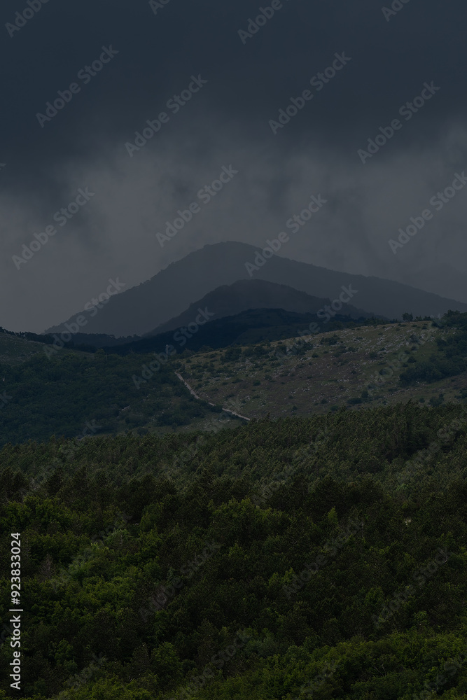 Fototapeta premium Dark storm clouds hang threateningly over the Croatian mountains.