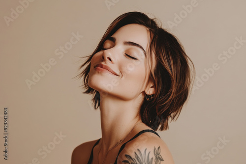 A close up of a woman's face with tattoos and her eyes closed