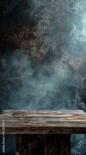 Wooden table with dark smoke background