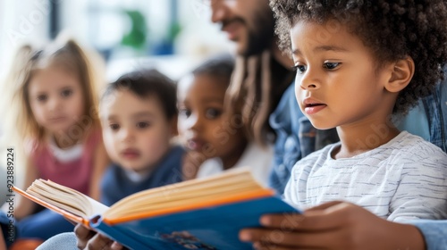Foster parent reading a book to a group of children
