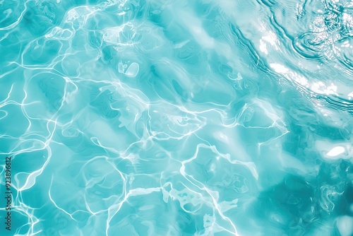 Sunlight softly reflects off blue water surface creating an abstract pattern. Perfect for use in backgrounds, wellness branding and summer projects.