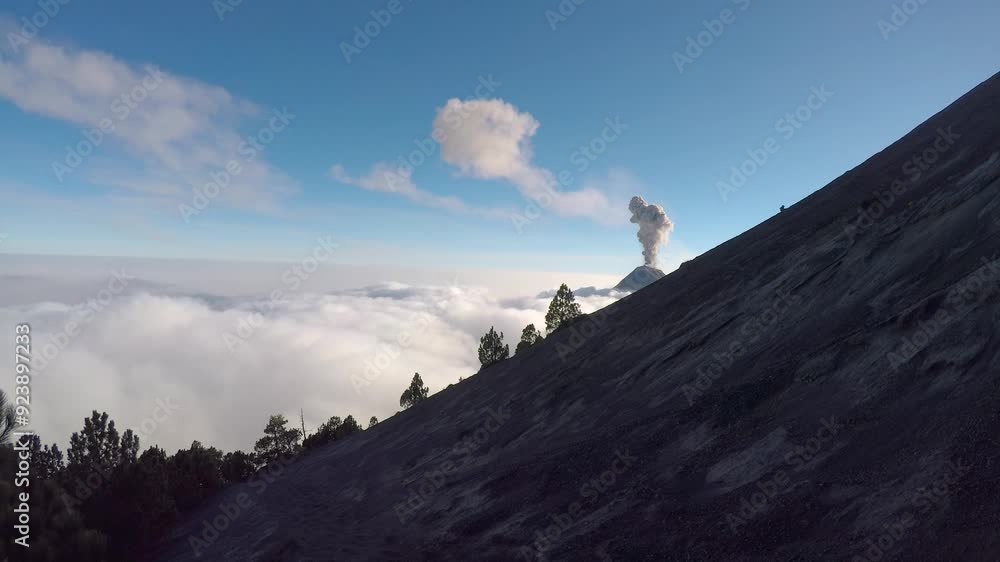 Volcano Fuego erupts above the clouds. Taken from Acatenango Volcano at sunset in Guatemala. Volcano Fuego erupts above the clouds. Taken from Acatenango Volcano at sunset in Guatemala.
