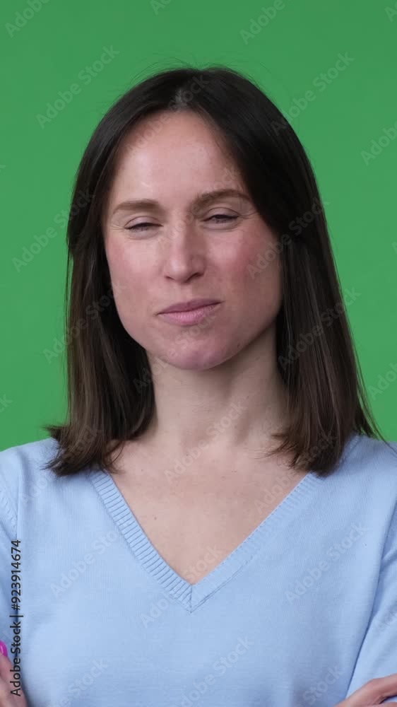 Portrait of a cheerful and confident Caucasian middle aged woman, positive lady looking at camera on green background. Vertical video. Portrait of a cheerful and confident Caucasian middle aged woman, positive lady looking at camera on green background. Vertical video.