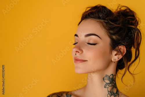 A close up of a woman's face with tattoos and her eyes closed