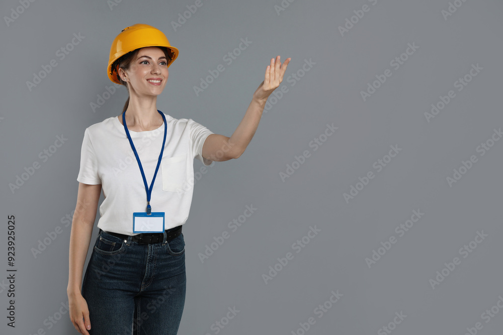 Engineer in hard hat on grey background, space for text Engineer in hard hat on grey background, space for text