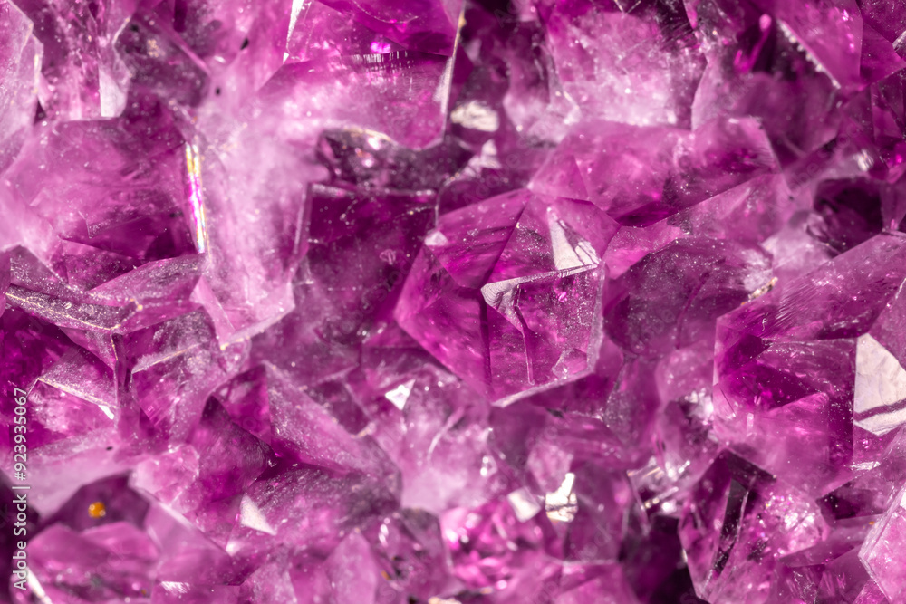 Fototapeta premium Amethyst purple crystals. Gems. Mineral crystals in the natural environment. Texture of precious and semiprecious stones. Seamless background with copy space colored shiny surface of precious stones.