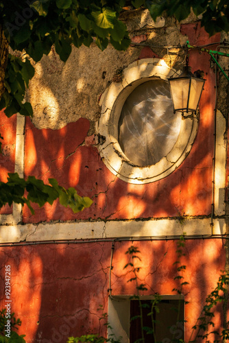 Obraz na płótnie Vintage Building Wall with Circular Window and Rustic Lantern w salonie