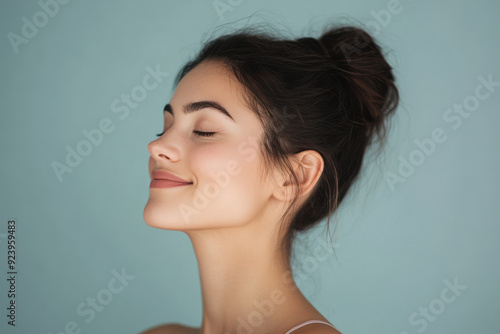 A close up of a woman's face with tattoos and her eyes closed