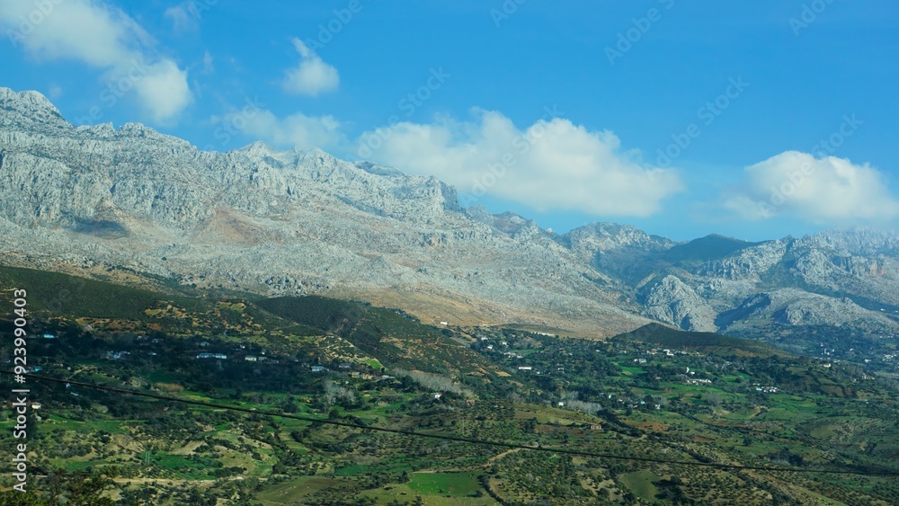 A stunning view of a rocky mountain range overlooking a lush green valley under a clear blue sky, highlighting the beauty of nature's contrast, Morocco.
A stunning view of a rocky mountain range overlooking a lush green valley under a clear blue sky, highlighting the beauty of nature's contrast, Morocco.