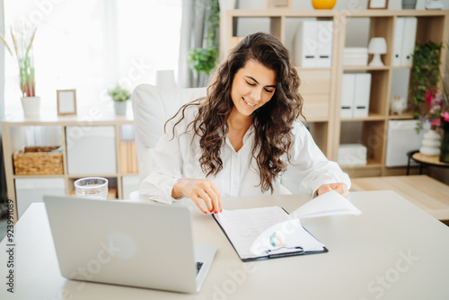 Young caucasian business woman working in office on laptop