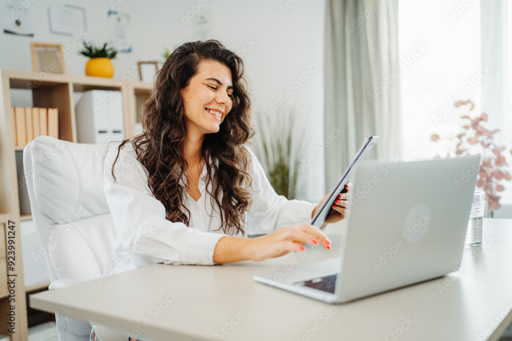 Young caucasian business woman working in office on laptop Young caucasian business woman working in office on laptop