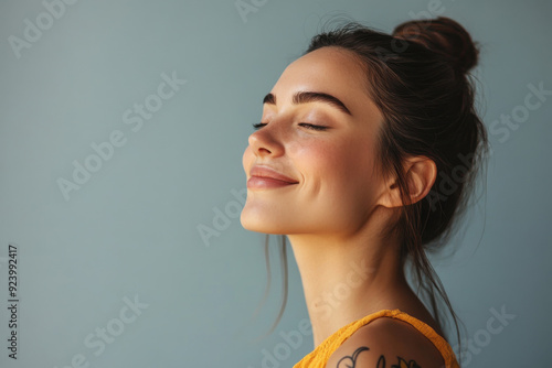 A close up of a woman's face with tattoos and her eyes closed