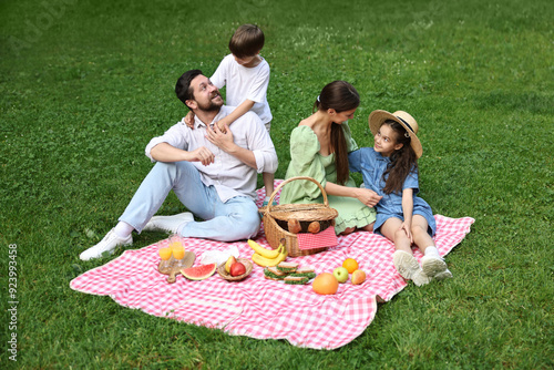 Happy family having picnic together in park photo