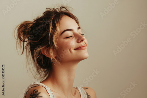 A close up of a woman's face with tattoos and her eyes closed